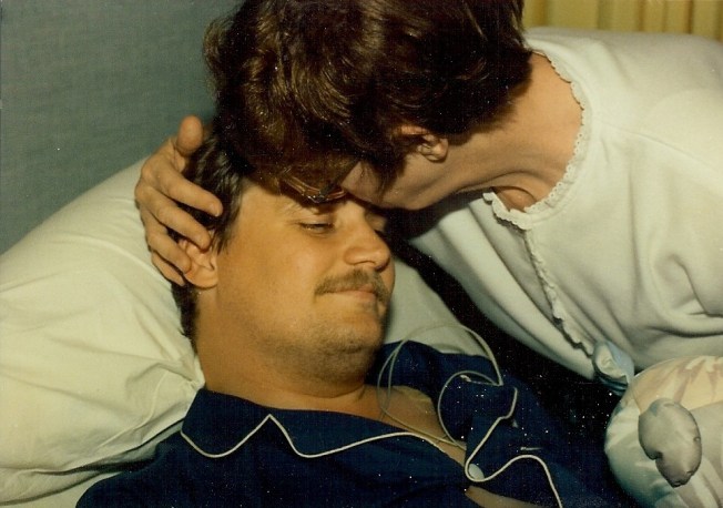 July 3, 1992.  Recovering from open heart surgery.  Mom tries to kiss it better.